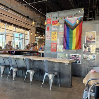 Sanitas Brewing - a bar with a rainbow flag hanging from the ceiling - Breweries Near Me - Englewood, Colorado Sanitas Brewing - a bar with a rainbow flag hanging from the ceiling - Breweries Near Me - Englewood, Colorado