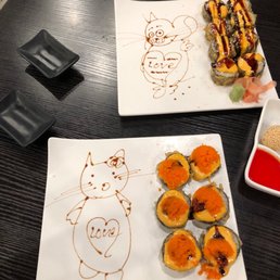 a plate of sushi and a plate of rolls