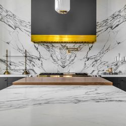 Your Kitchen & Bath - Custom matte black Modernaire hood with gold trim.