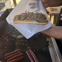 Azars East Side Grill - Foot long Philly cheesesteak. Thinly sliced ribeye, sharp white cheddar and grilled onions.