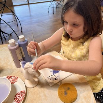 Petroglyph Ceramic Lounge - My niece painting her unicorn for her birthday. - Paint-Your-Own Pottery Near Me - Roseville, California