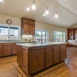 Rochelle Interiors - Santa Rosa Open Concept kitchen and family room with Quartzite fireplace surround.