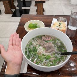 The bowl of pho is massive (hand for scale)! This is the Flank & Brisket Pho! The bowl of pho is massive (hand for scale)! This is the Flank & Brisket Pho!