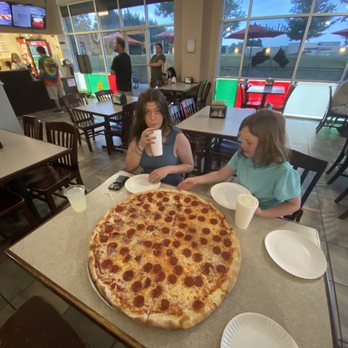 Frankie's Pizza - two girls sitting at a table with a large pepperoni pizza - Pizza Near Me - Granite Falls, North Carolina Frankie's Pizza - two girls sitting at a table with a large pepperoni pizza - Pizza Near Me - Granite Falls, North Carolina