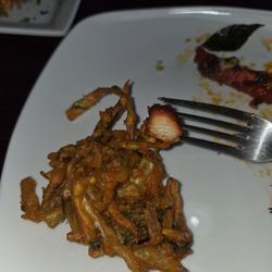 A Piece Of Vegetable Pakora And What The Inside Of The Chicken 65 Looks Like.
