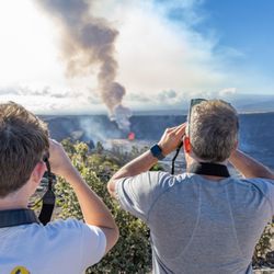 Big Island Backroad Adventures - Kona private tour guests looking at Kilauea volcano erupting.