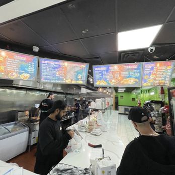 Halal Munchies - customers at the counter - Halal Near Me - Astoria, New York