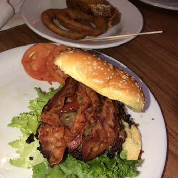 Denny's - Burnt BYO beef burger with crispy bacon.Overcooked onion rings in background. - Diners Near Me - Carlisle, Pennsylvania Denny's - Burnt BYO beef burger with crispy bacon.Overcooked onion rings in background. - Diners Near Me - Carlisle, Pennsylvania