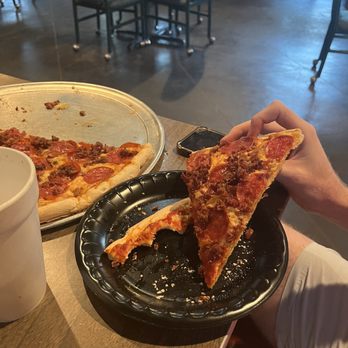 The Pizza Den - Slice of a large pepperoni and bacon pizza - Italian Near Me - Oxford, Mississippi