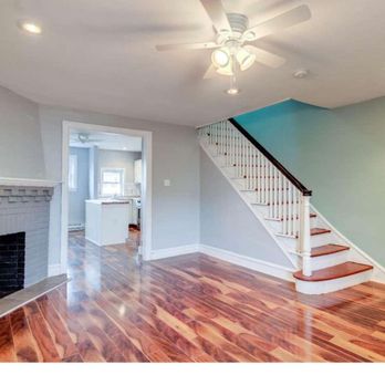 Bangs Construction - a living room with hardwood floors and a fireplace - General Contractors Near Me Bangs Construction - a living room with hardwood floors and a fireplace - General Contractors Near Me