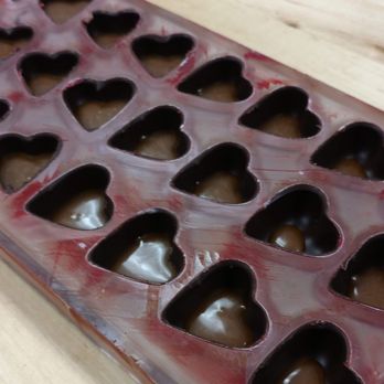 Feve Artisan Chocolatier - Filling caramel into chocolate shell. Custom your caramel levels! - Chocolatiers & Shops Near Me - San Francisco, California Feve Artisan Chocolatier - Filling caramel into chocolate shell. Custom your caramel levels! - Chocolatiers & Shops Near Me - San Francisco, California