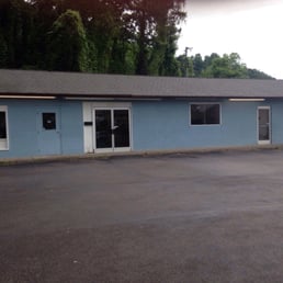 Front of laundromat in a blue building
