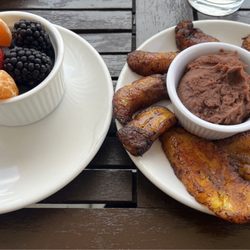 Fresh fruit: strawberries, oranges, blackberries, and blueberries. Fried Plantain with refried beans.