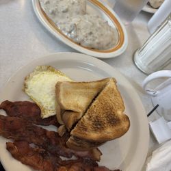 D & B Cafe - Bacon perfectly crisp. Eggs over medium and toast and biscuits and gravy!