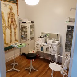 Exam room of office of Natan Schleider MD with refinished vintage medical furnishings and brand new ECG machine