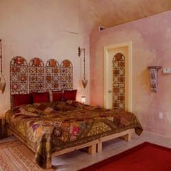 The exotic Moroccan room with vaulted ceiling, an organic king bed and chromatherapy spa tub room.