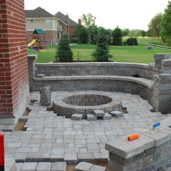 Green Landscape Solutions - a brick patio with a fire pit - Landscaping Near Me Green Landscape Solutions - a brick patio with a fire pit - Landscaping Near Me