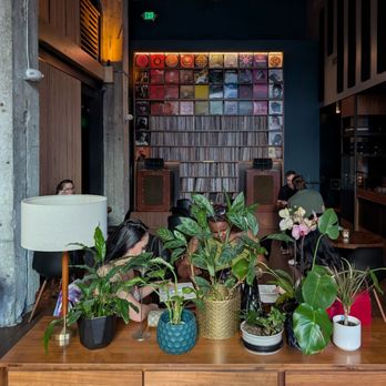Bar Shiru - Large wall of vinyl along back wall and DJ booth on the right - Cocktail Bars Near Me - Oakland, California