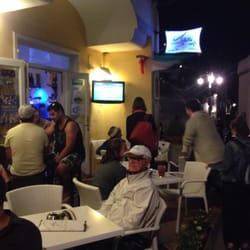 Sibilla Cafe - Front of building with tables and outdoor TV to watch the World Cup