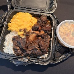 Oxtails white rice Mac & Cheese, cabbage