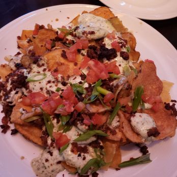 Marlow's Tavern - Homemade kettle chip app with bacon tomatoes scallions and gorgonzola cheese - New American Near Me - Orlando, Florida Marlow's Tavern - Homemade kettle chip app with bacon tomatoes scallions and gorgonzola cheese - New American Near Me - Orlando, Florida