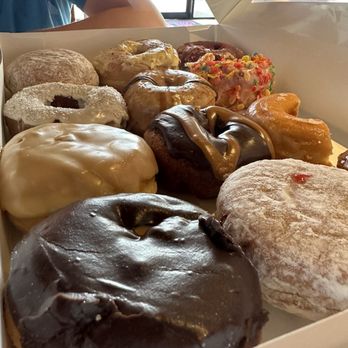 Donut Kingdom - Close up on the dozen! That Boston Crème is going to be amazing! - Donuts Near Me - Tallahassee, Florida