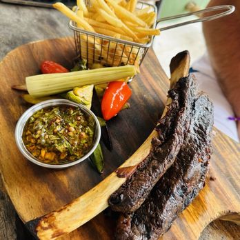 Ocean Grill - BEEF SHORT RIBS Slow-smoked beef short ribs, chimichurri on the side, served with exotic veggies and french fries - Steakhouses Near Me - Puerto Vallarta, JAL Ocean Grill - BEEF SHORT RIBS Slow-smoked beef short ribs, chimichurri on the side, served with exotic veggies and french fries - Steakhouses Near Me - Puerto Vallarta, JAL