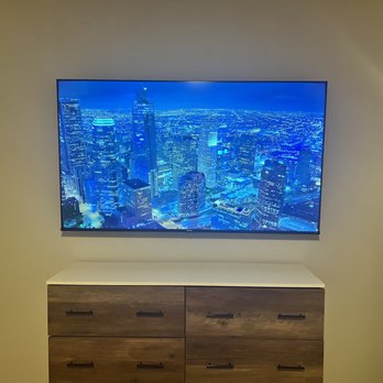 Intact Installs - 65 inch TV + Apple TV mounted without wires showing in an apartment - TV Mounting Near Me Intact Installs - 65 inch TV + Apple TV mounted without wires showing in an apartment - TV Mounting Near Me
