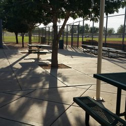 Picnic tables, trees, grass, make for a nice park