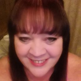 a smiling woman in a pink tank top