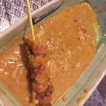 Thai Boat - (SORRY FOR PARTIALLY EATEN PHOTO) Chicken Satay: Small cuts of chicken drenched in sauce - Thai Near Me - Calgary, Alberta