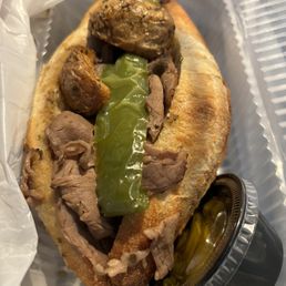 a sandwich with meat and pickles a sandwich with meat and pickles