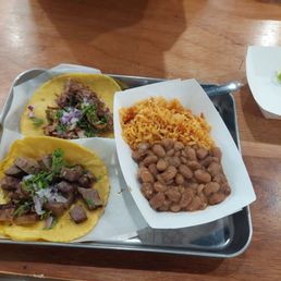 Two tacos plate (One Carnitas and one Lengua) with rice and beans. Two tacos plate (One Carnitas and one Lengua) with rice and beans.