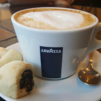 Scafuri Bakery - Cappucino with fig cookie in the front and lemon twist in the back - Bakeries Near Me - Chicago, Illinois Scafuri Bakery - Cappucino with fig cookie in the front and lemon twist in the back - Bakeries Near Me - Chicago, Illinois