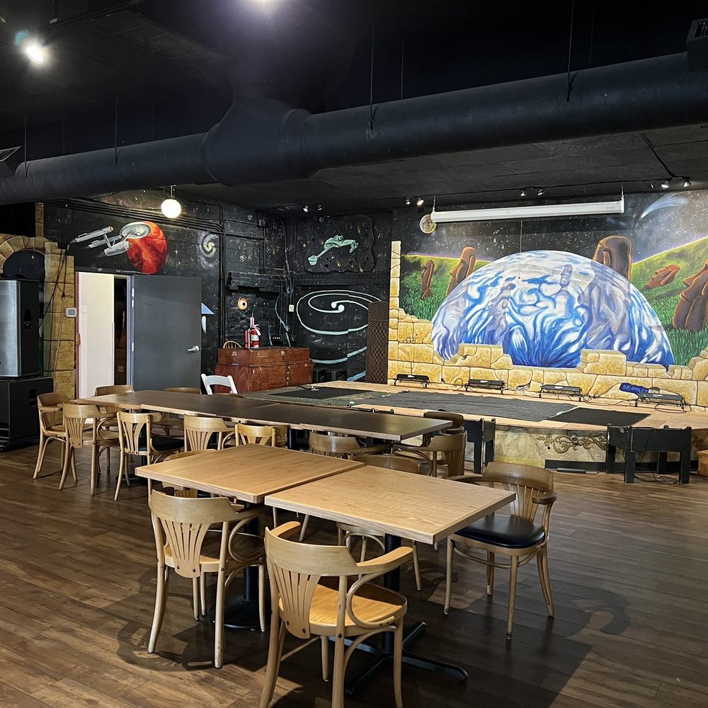 a dining area with tables and chairs
