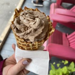The Real Scoop Ice Cream & Espresso Shop - Chocolate ice cream with coconut mixed in in a waffle cone