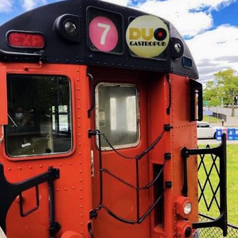 DUO Gastropub - a train at a station - Gastropubs Near Me - Queens, New York