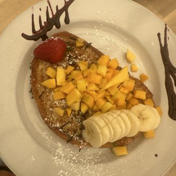 Naked Cafe - Coconut French Toast & added mango - Breakfast & Brunch Near Me - Solana Beach, California Naked Cafe - Coconut French Toast & added mango - Breakfast & Brunch Near Me - Solana Beach, California