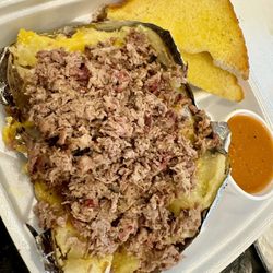 Mike's Real Pit Bar-B-Q - Jumbo baked potato with Brisket.  There's butter, sour cream, and cheese under all the meat!