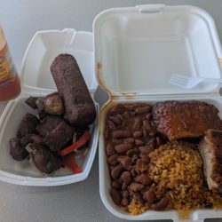 Papo Guacaros Place - Pork belly with fried crackling skin, yellow rice and beans, fried cubed slices of pork and an alcapurria