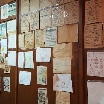 Lisa Pizzeria - a wall covered with papers - Pizza Near Me - Janesville, Wisconsin Lisa Pizzeria - a wall covered with papers - Pizza Near Me - Janesville, Wisconsin