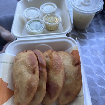 Pa' Paraguana - Empanada comes with sauces and cole slaw. That's a small soursop juice next to the sauces. - Empanadas Near Me - Kissimmee, Florida Pa' Paraguana - Empanada comes with sauces and cole slaw. That's a small soursop juice next to the sauces. - Empanadas Near Me - Kissimmee, Florida