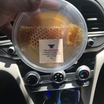 The Honey Shop - a person holding a cup of honey - Honey Near Me - Woonsocket, Rhode Island The Honey Shop - a person holding a cup of honey - Honey Near Me - Woonsocket, Rhode Island