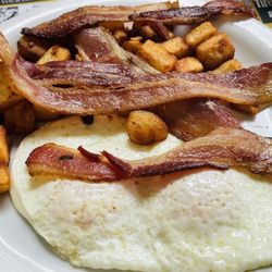 Two eggs over with bacon and home fries