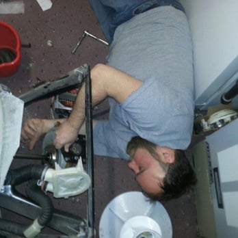 Appliance Ace Repairs - Joe installing a transmission in a washer. - Appliances & Repair Near Me