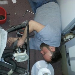 Appliance Ace Repairs - Joe installing a transmission in a washer.