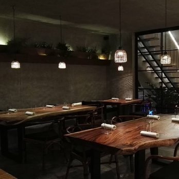Toyo Eatery - kitchen area with acacia tables and and metal accents - Filipino Near Me - Makati, NCR