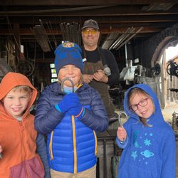 The Square - Blacksmith George made steel candy canes for all three grandkids!  They loved it!