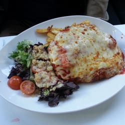 The Orchard Tavern - Chicken Schnitzel BCT panko crumbed, bacon, cheese, tomato, chips, salad. $18
