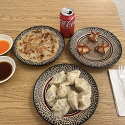 Royal Dumplings House - This is a combination plate of pork and shrimp dumplings in the sauces. It comes with and cream cheese, wontons, and scallion pancake.